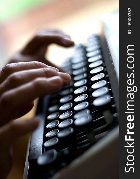 Index finger pressing down on a typewriter key. Index finger pressing down on a typewriter key.