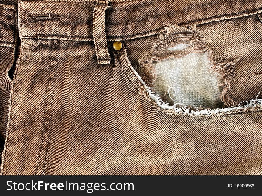 Torn old brown jeans background,dirty pants. Torn old brown jeans background,dirty pants