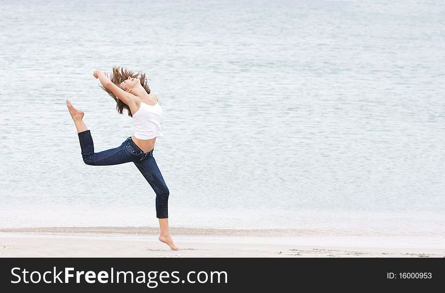 Young girl doing gymnastics on beach