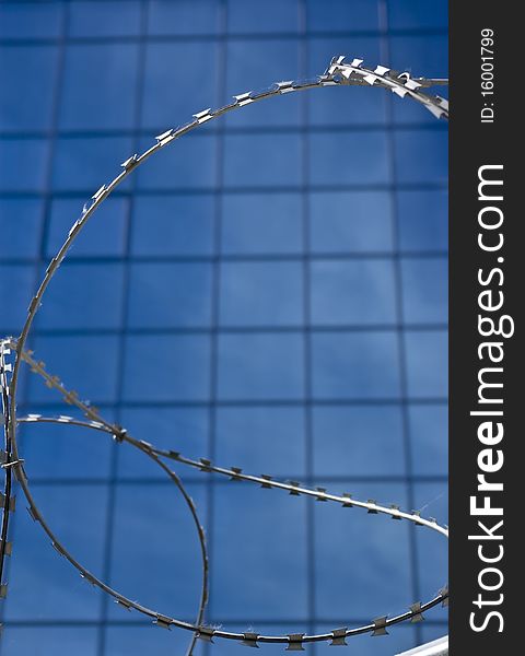 Barbed wire on a background of office building