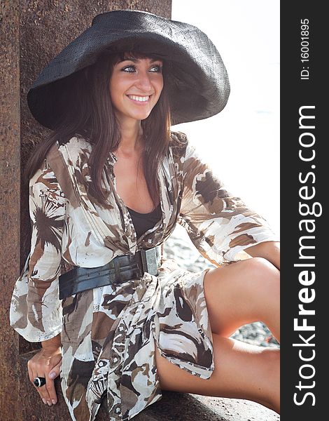 Young female wearing summer dress and hat, brightly backlit. Young female wearing summer dress and hat, brightly backlit.