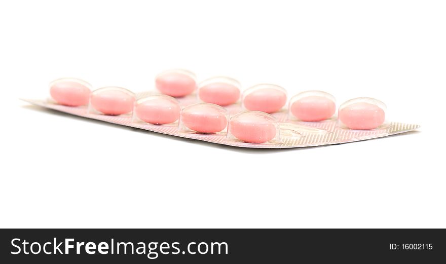 White round pills on the white isolated background