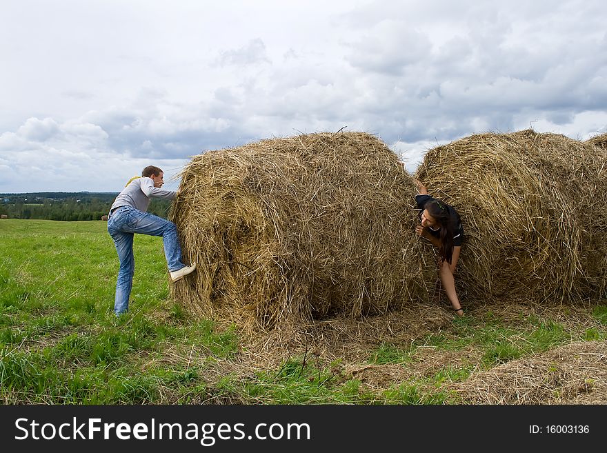 Young couple costs about a haystack