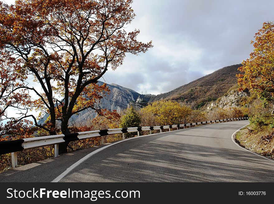 The road in mountains autumn yellow foliage