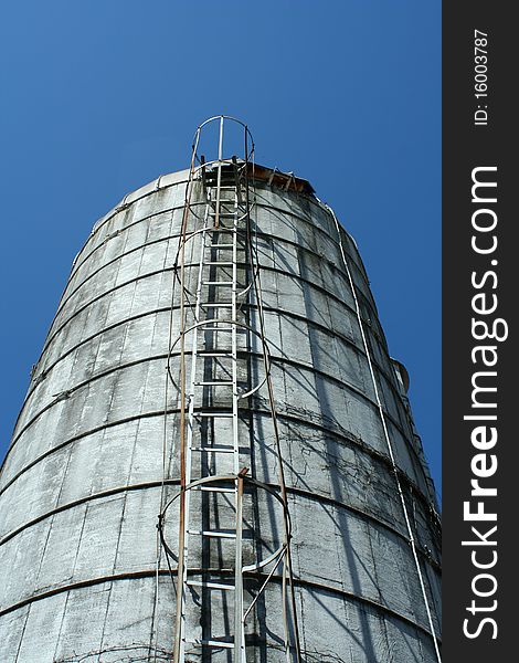 Looking up a grain silo with blue sky
