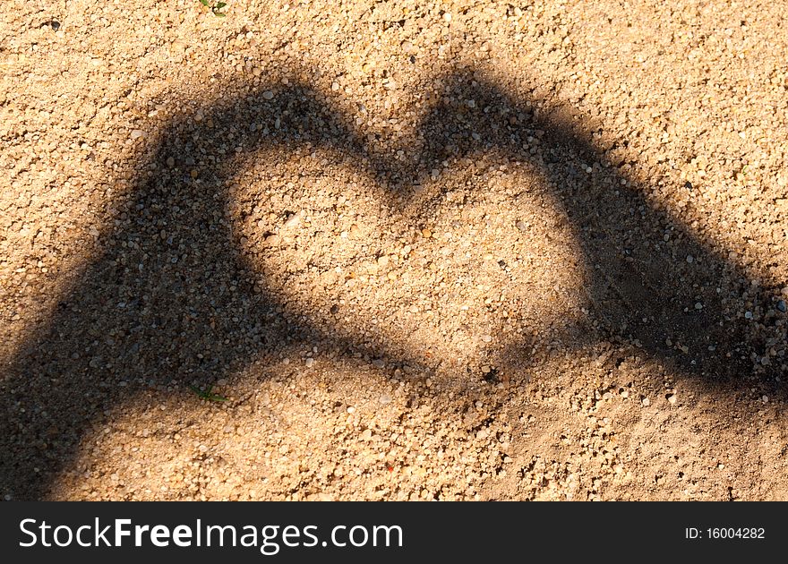 The heart of the shadows made by hand in the sand