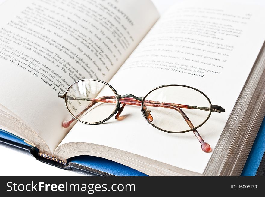 A book with old eye glass. A book with old eye glass