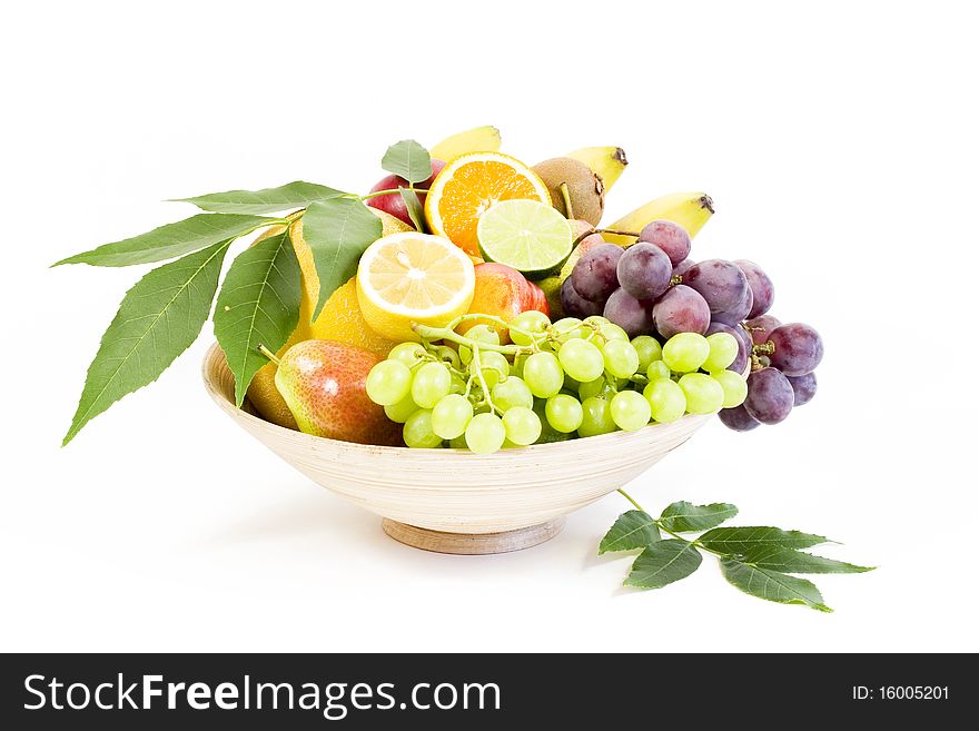 Full bamboo plate of fresh fruits isolated on white