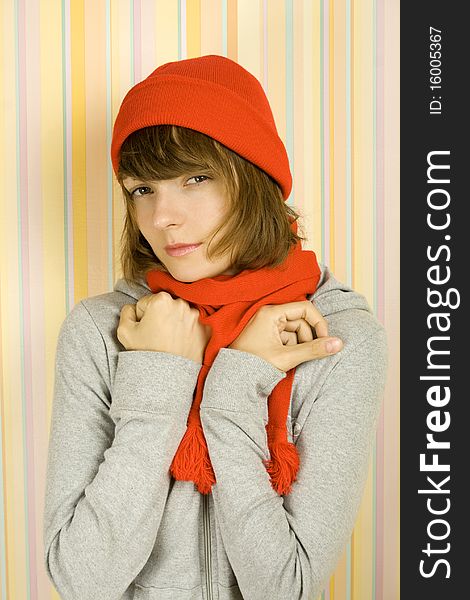 Photo of a young woman in a gray bike with a red knitted hat and scarf. Freezes. Photo of a young woman in a gray bike with a red knitted hat and scarf. Freezes