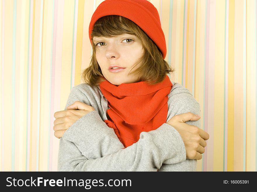 Photo of a young woman in a gray bike with a red knitted hat and scarf. Freezes. Photo of a young woman in a gray bike with a red knitted hat and scarf. Freezes