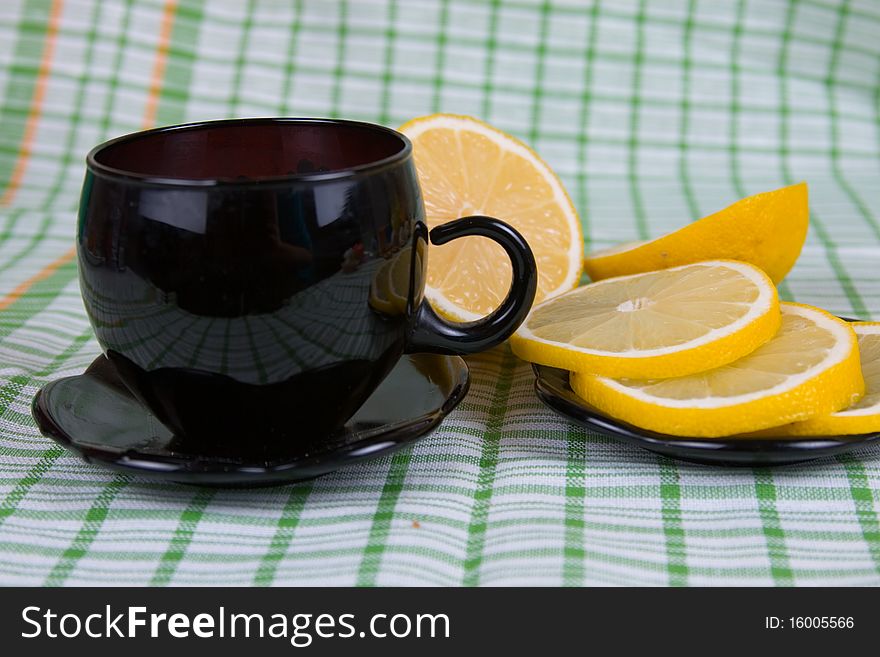 Tea with lemon on a green napkin