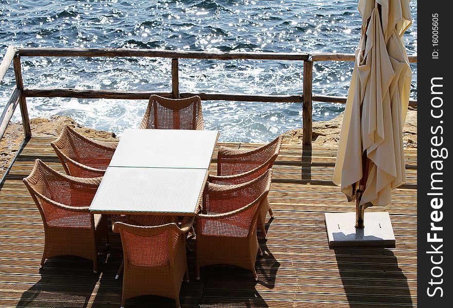 Table and chairs on a terrace overlooking the island Crete. Table and chairs on a terrace overlooking the island Crete