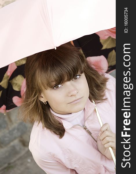 Girl with a pink umbrella on the street. Girl with a pink umbrella on the street