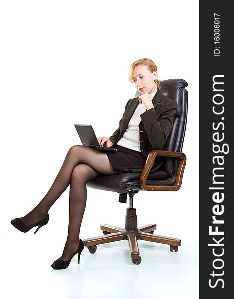 Business woman with laptop sitting in a chair