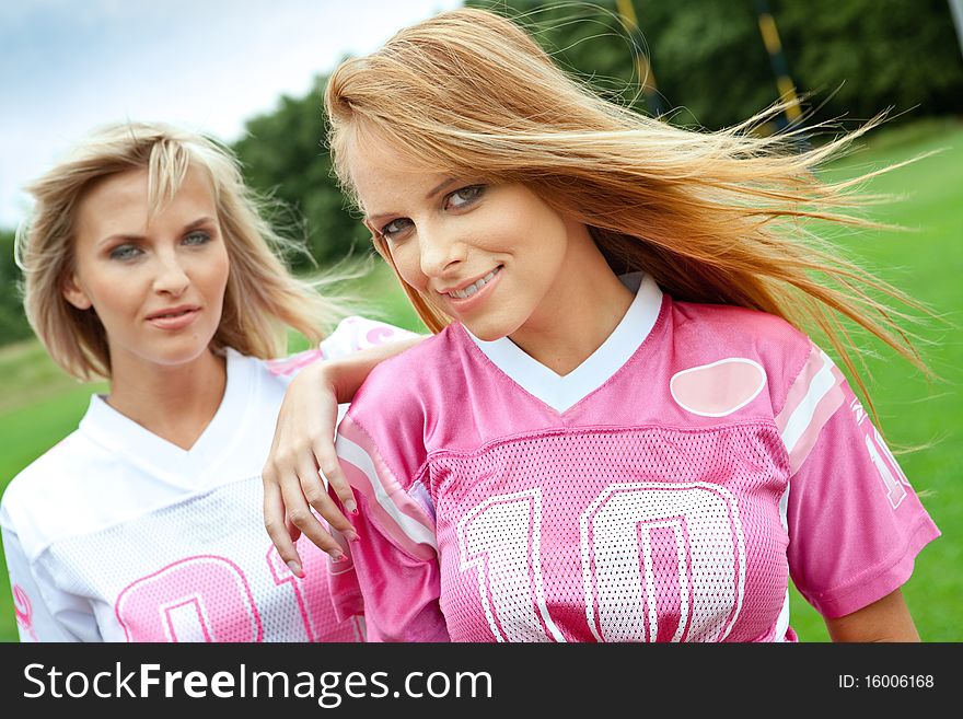 Two pretty girls on a sportsfield. Two pretty girls on a sportsfield