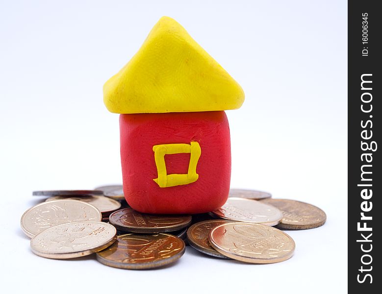 Photo of the plasticine house on coins. Photo of the plasticine house on coins