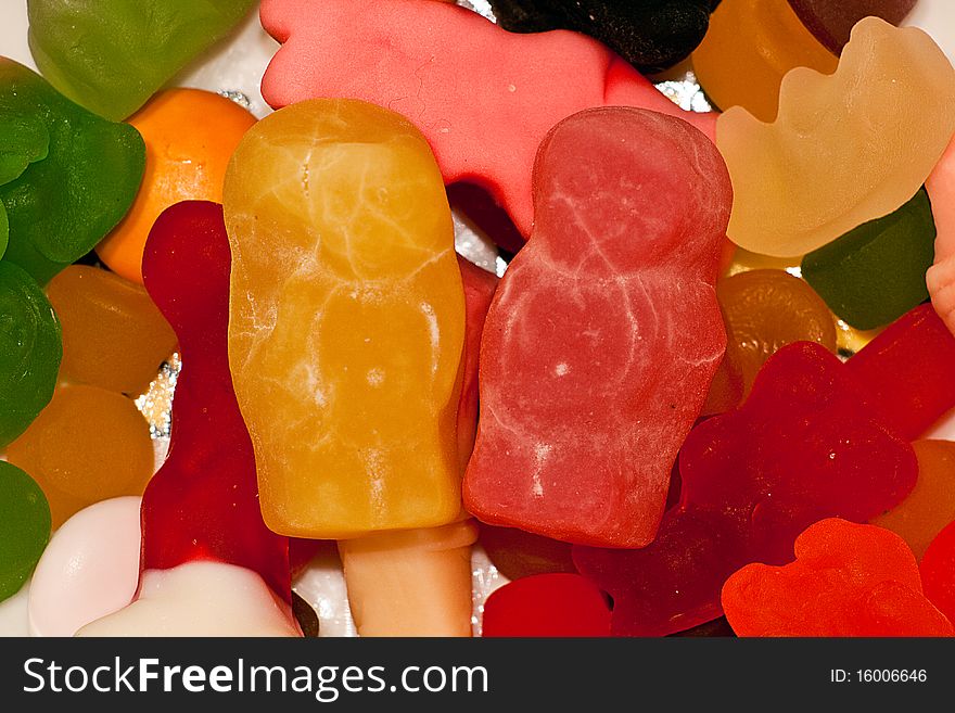 A macro shot of two jellybabies amid a collection of sweets. A macro shot of two jellybabies amid a collection of sweets