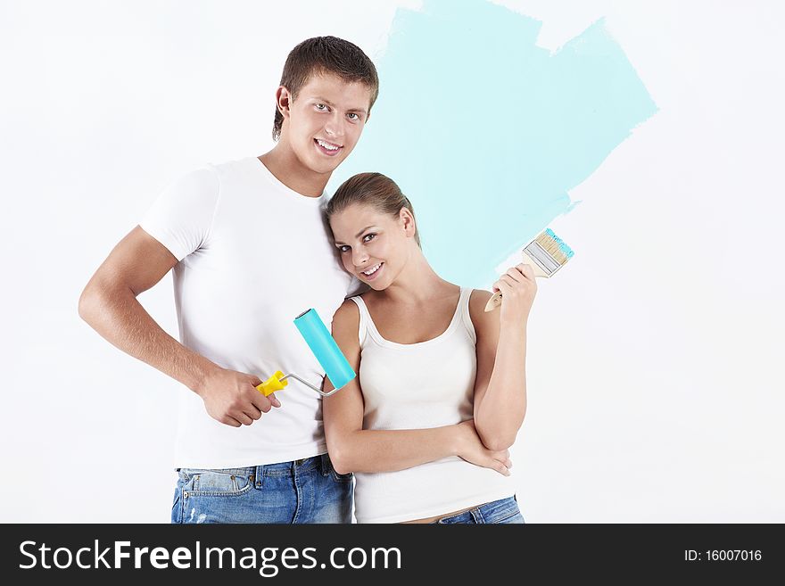 Young attractive couple on the background of painted wall. Young attractive couple on the background of painted wall