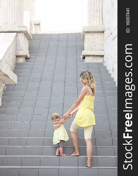 Mom and daughter climb the stairs