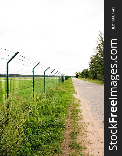 Road with intake with green grass by the side