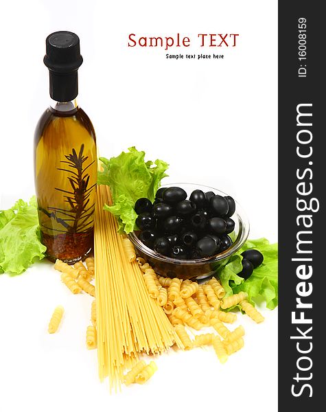 A bottle of olive oil with pasta and black olives isolated on a white background.