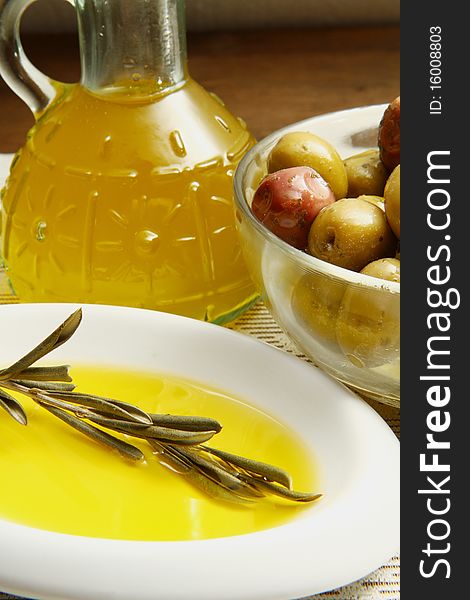 Extra virgin olive oil and a branch with fresh olives. Extra virgin olive oil and a branch with fresh olives