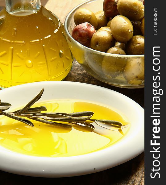 Extra virgin olive oil and a branch with fresh olives. Extra virgin olive oil and a branch with fresh olives