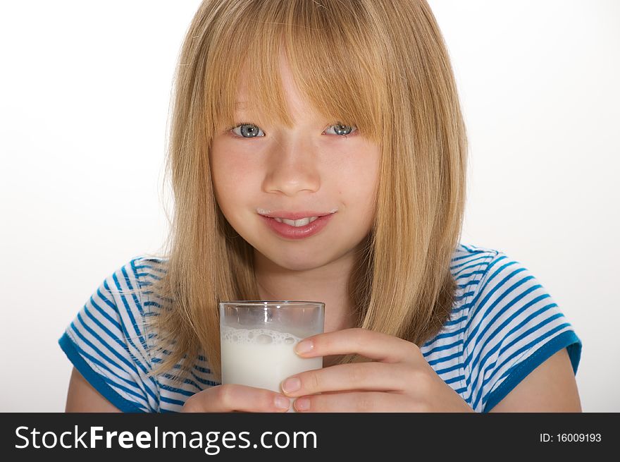 Young girl drinking a glass of milk. Young girl drinking a glass of milk