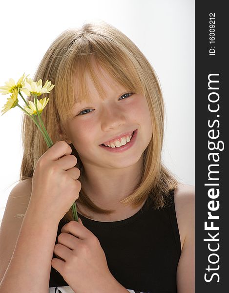 Young girl smiling and holding a bunch of daisies. Young girl smiling and holding a bunch of daisies