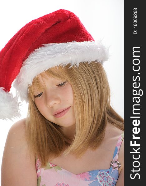 Young girl smiling and wearing a santa hat. Young girl smiling and wearing a santa hat