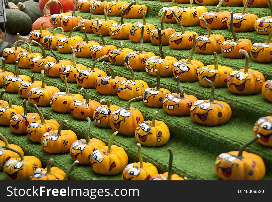 Rows of comical painted gourds in the fall