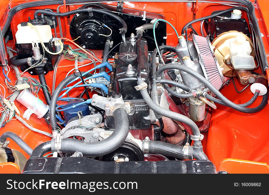 Closeup on a sports car engine, pipes and cables. Closeup on a sports car engine, pipes and cables