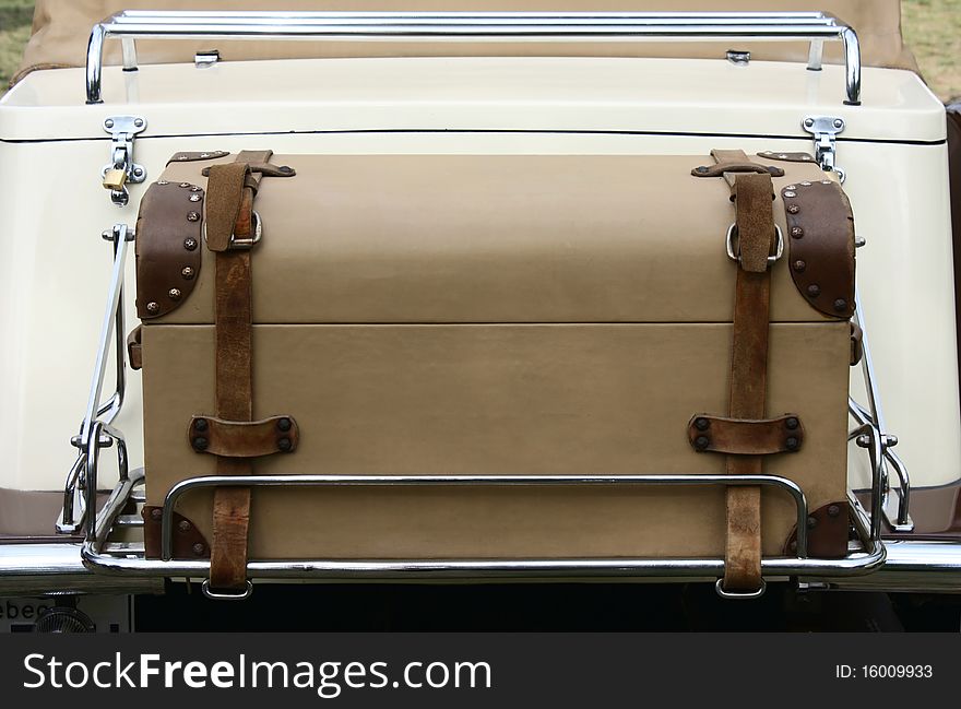 Vintage suitcase at the back of a car trunk