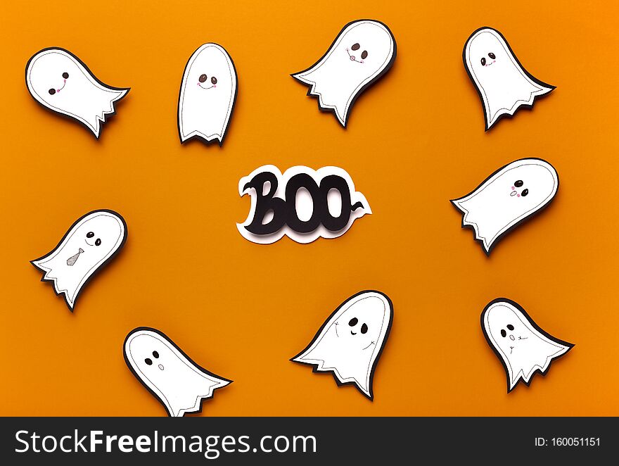 Spooktacular Halloween ghosts flying on orange background with boo scary text