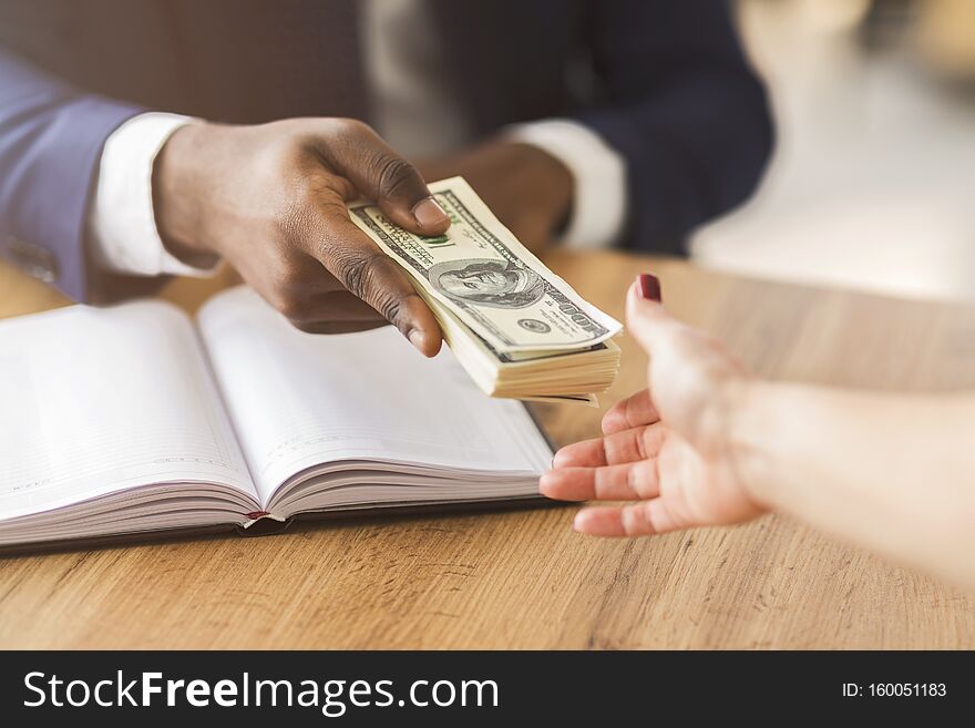 Corrupted businessman making black deal, giving partner venality bribe money
