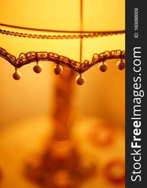 Fabric Lampshade With Golden Balls And Warm Light. Close-up, Selective Focus