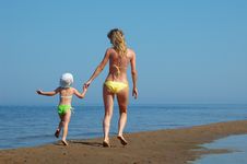 Mother With Child On The Beach Stock Images
