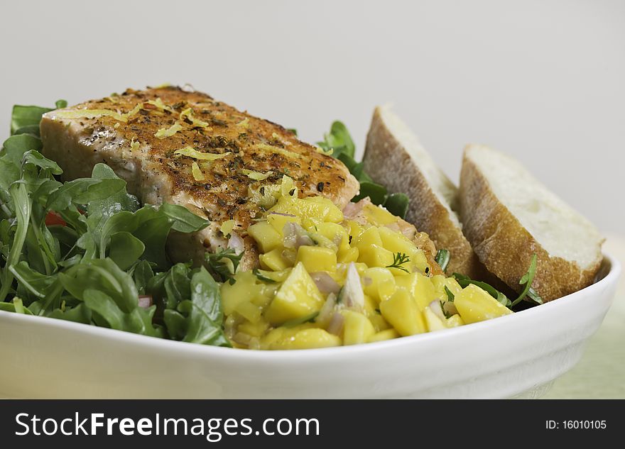 Grilled atlantic salmon fish on salad. Fruit salsa on the side. Very sharp. Grilled atlantic salmon fish on salad. Fruit salsa on the side. Very sharp.