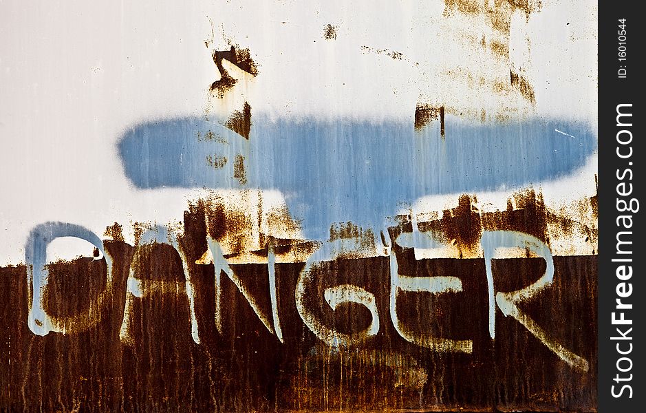 Grunge danger sign spray painted on a wall. Grunge danger sign spray painted on a wall