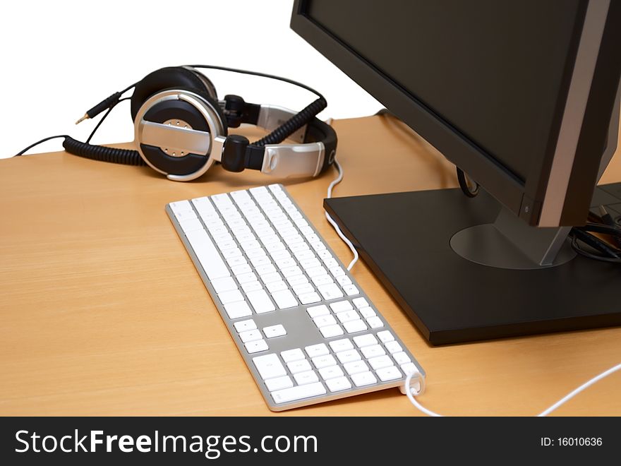 Monitor with headsets in the table, isolated on white