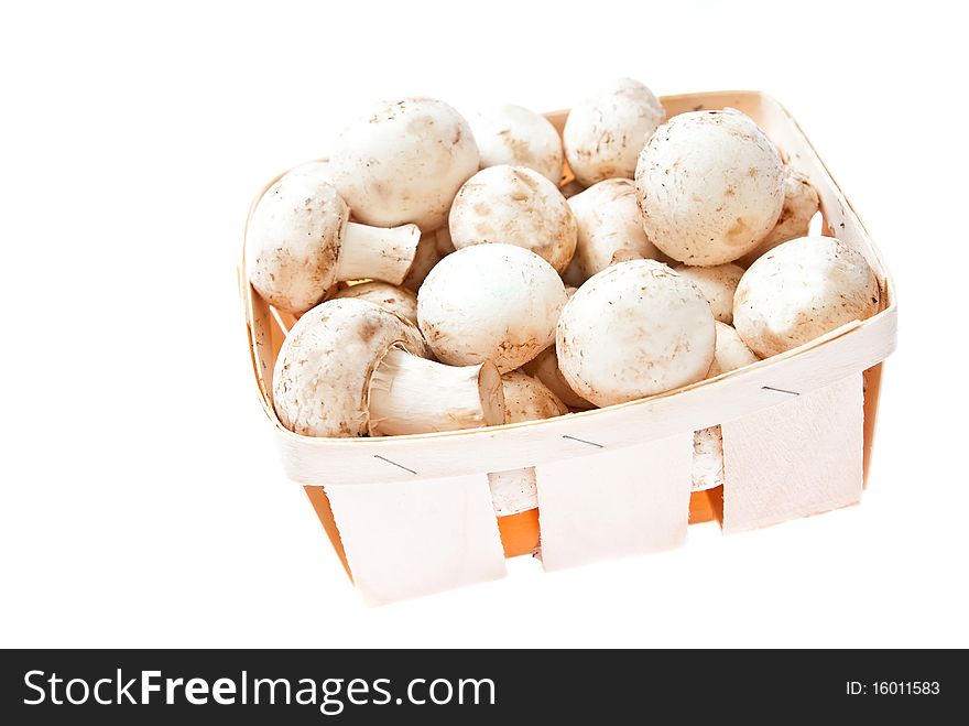 Raw mushrooms in box on white background