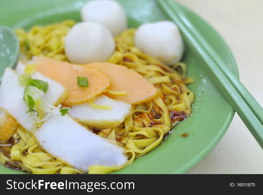 Sumptuous looking Oriental fishball noodles with generous toppings of fishballs and fish cake. Suitable for concepts such as food and beverage, and travel and cuisine.