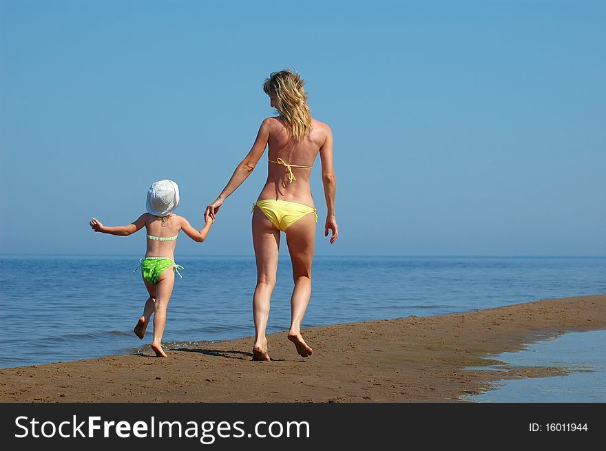 Mother with child have fun on the beach. Mother with child have fun on the beach