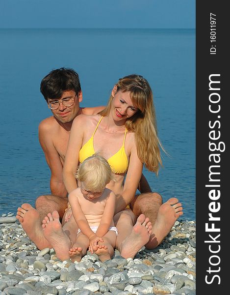 Happy family sit on the beach