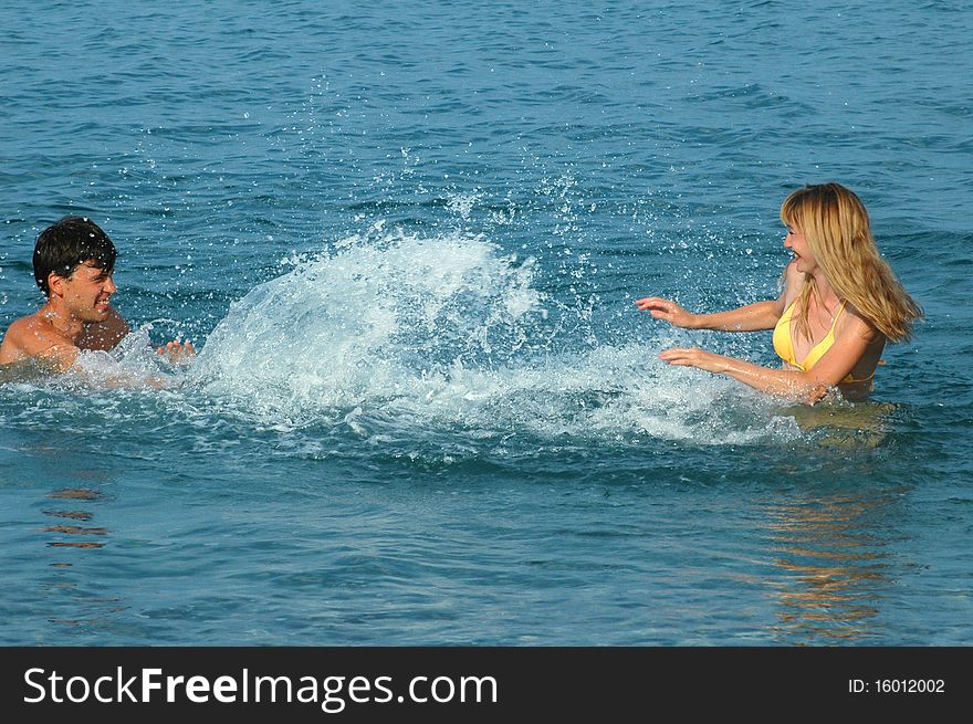 Happy couple have fun in the sea