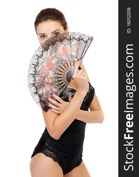 Young fashion model posing in underwear with a folding fan isolated on white