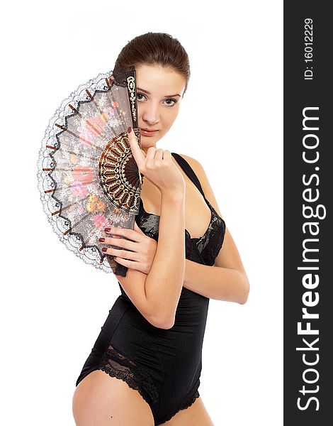 Young fashion model posing in underwear with a folding fan isolated on white