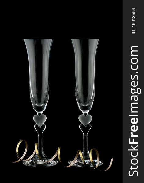 Studio shot of two empty generic champagne glass on black