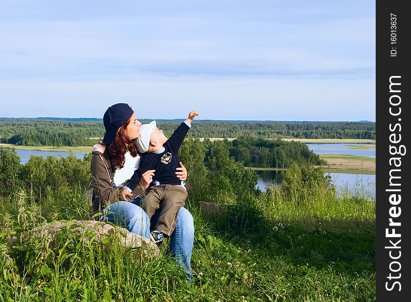 Mother and son in park near lake