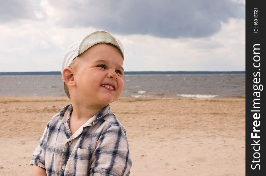 Smiling boy play on a beach. Smiling boy play on a beach